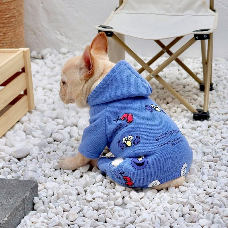 Blue graphic hooded romper on Frenchie — rear three-quarter view on pebbles