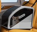 Grey pet car safety seat secured on car seat with dog — in-car use with headrest strap