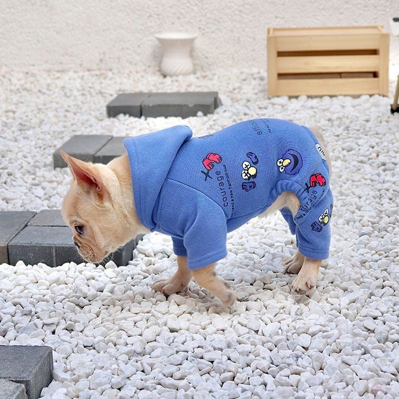 Blue graphic hooded romper — side standing view on pebbles