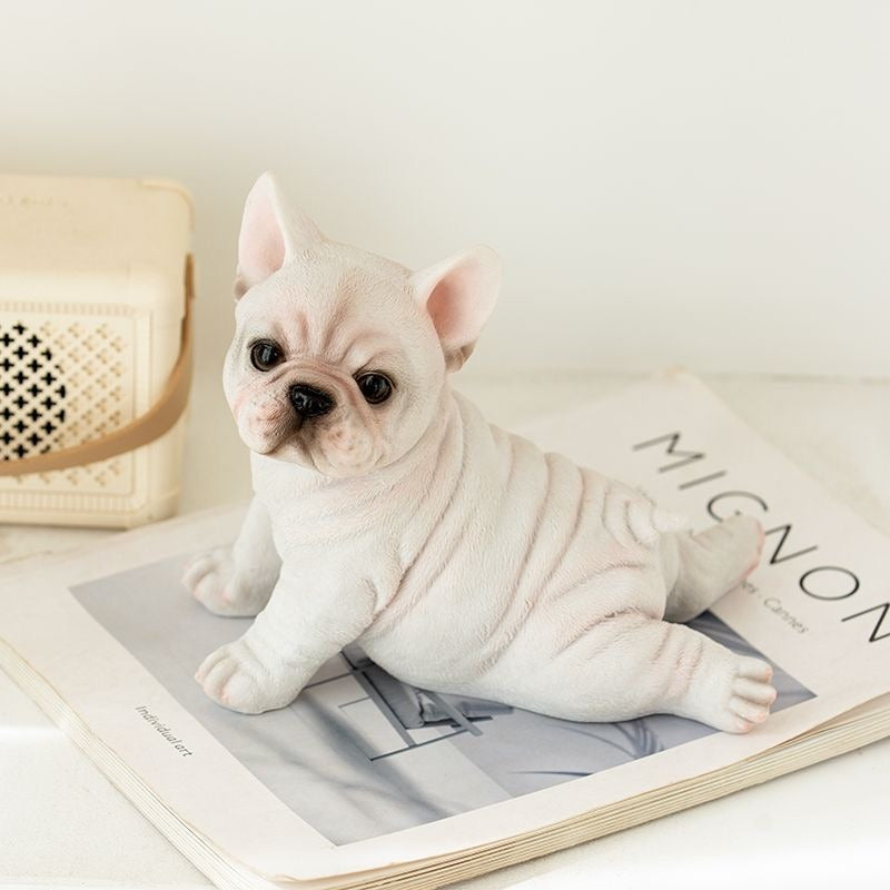 Cream prone Frenchie resin figurine on magazine