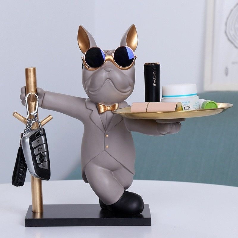 Grey tuxedo Frenchie key rack with gold tray and key hooks — lifestyle