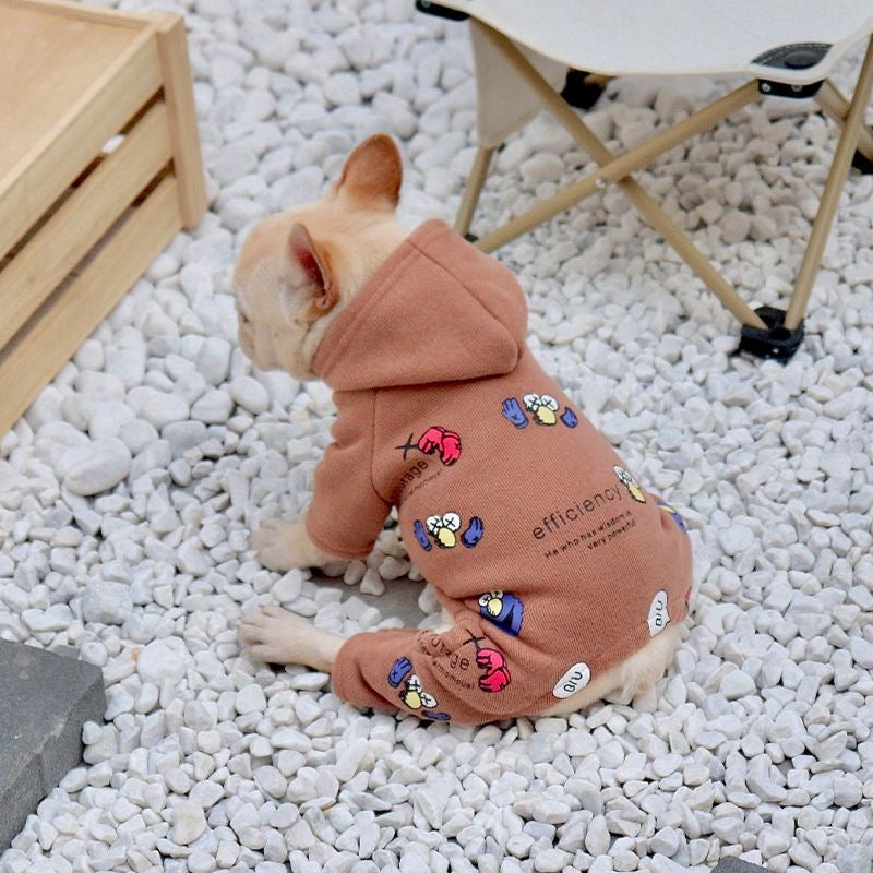 Terracotta graphic hooded romper on Frenchie — rear view on pebbles