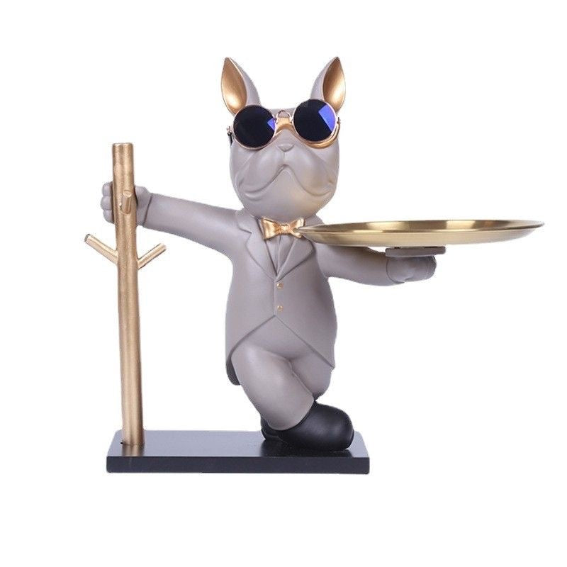 Beige tuxedo Frenchie key rack with gold tray and key hooks — studio