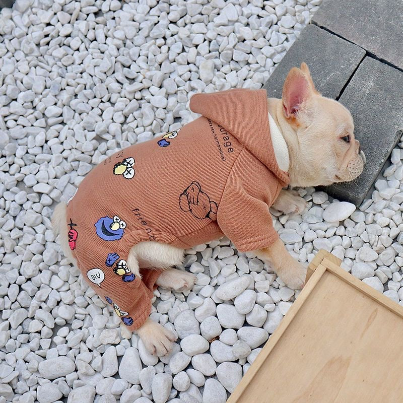 Camel graphic hooded romper on Frenchie — lying on pebbles