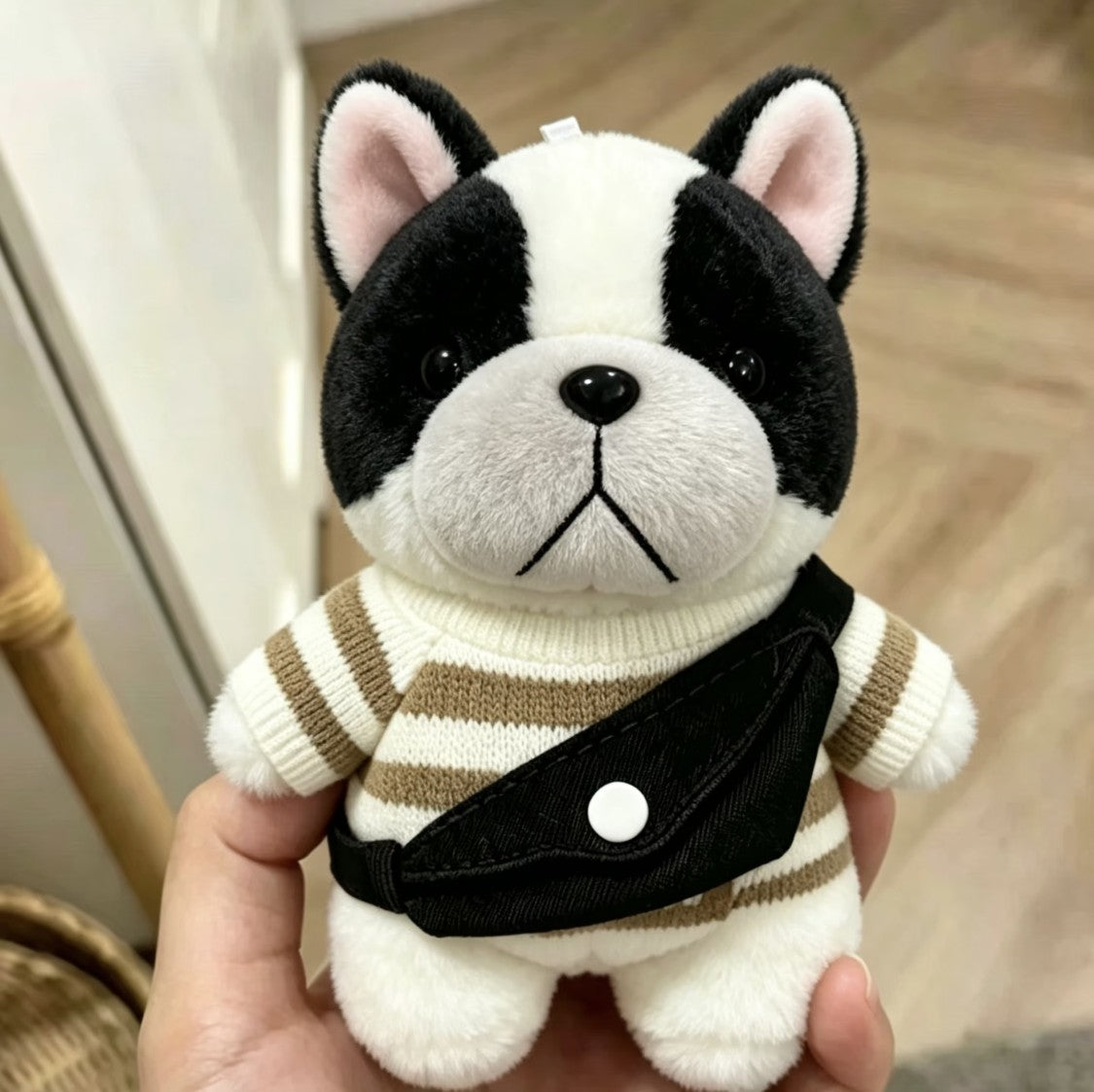 Pied Frenchie plush bag charm in striped sweater and black bag
