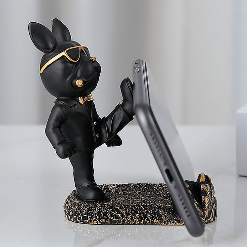 Black suit Frenchie resin phone stand holding a phone