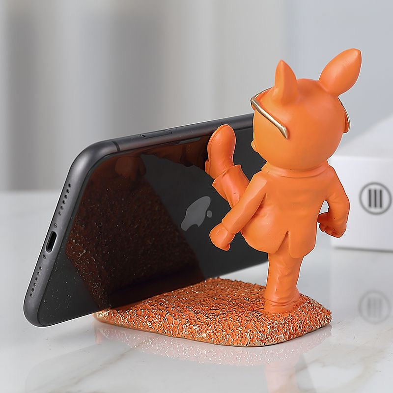 Orange suit Frenchie resin phone stand with phone in landscape