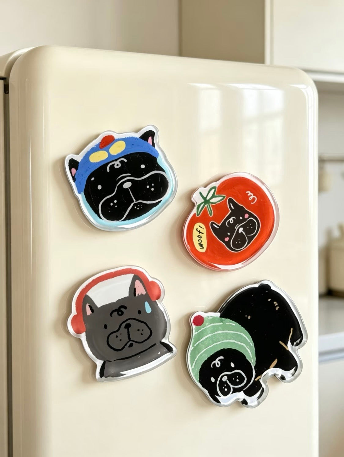 Set of four cute Frenchie acrylic fridge magnets on a fridge